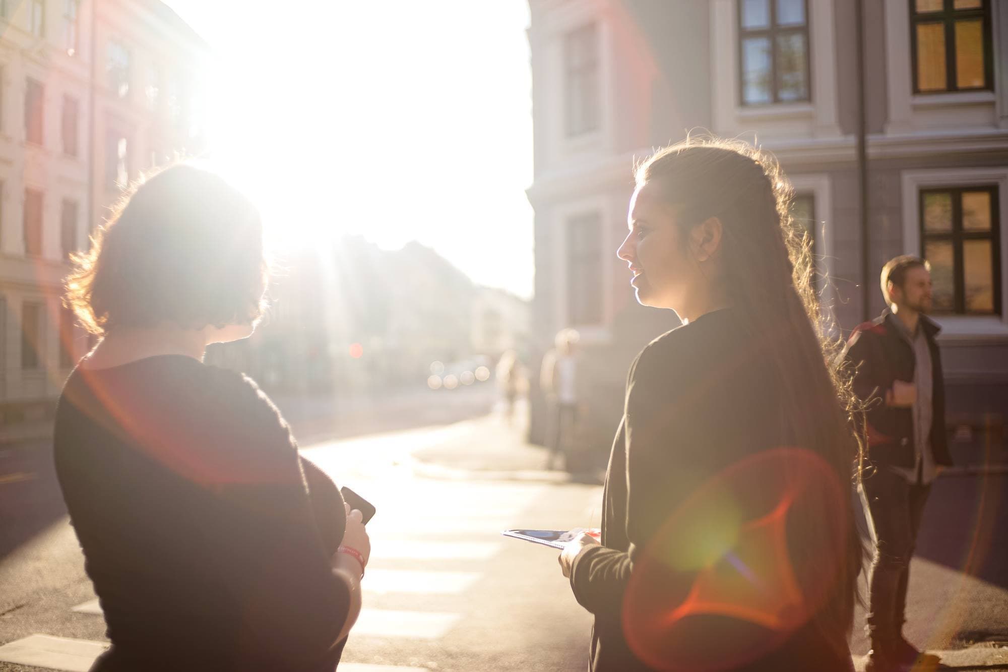 Two founders talking through an idea in the city